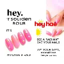 A digital advertisement, vertical layout, features five artificial nails with pink-to-gold gradient, star and line decorations. Bold black 'hey,' and smaller 'IT'S GOLDEN HOUR', large red 'heyhae' with yellow sunbu.webp