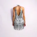 Surreal image of a shiny silver fringe mini dress, halter neck and backless style, on a white backdrop. Dreamlike imagery, smooth gradient transitions, fantastical elements, bizarre scenes.webp