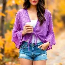High-resolution stock photo of warm autumn colors. A woman with light skin and dark hair wears a lavender purple sheer mesh shrug with bell sleeves and a tie-front, styled with distressed denim shorts and rings.  A.webp